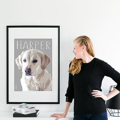 Lady looking at her custom pet art of her puppy